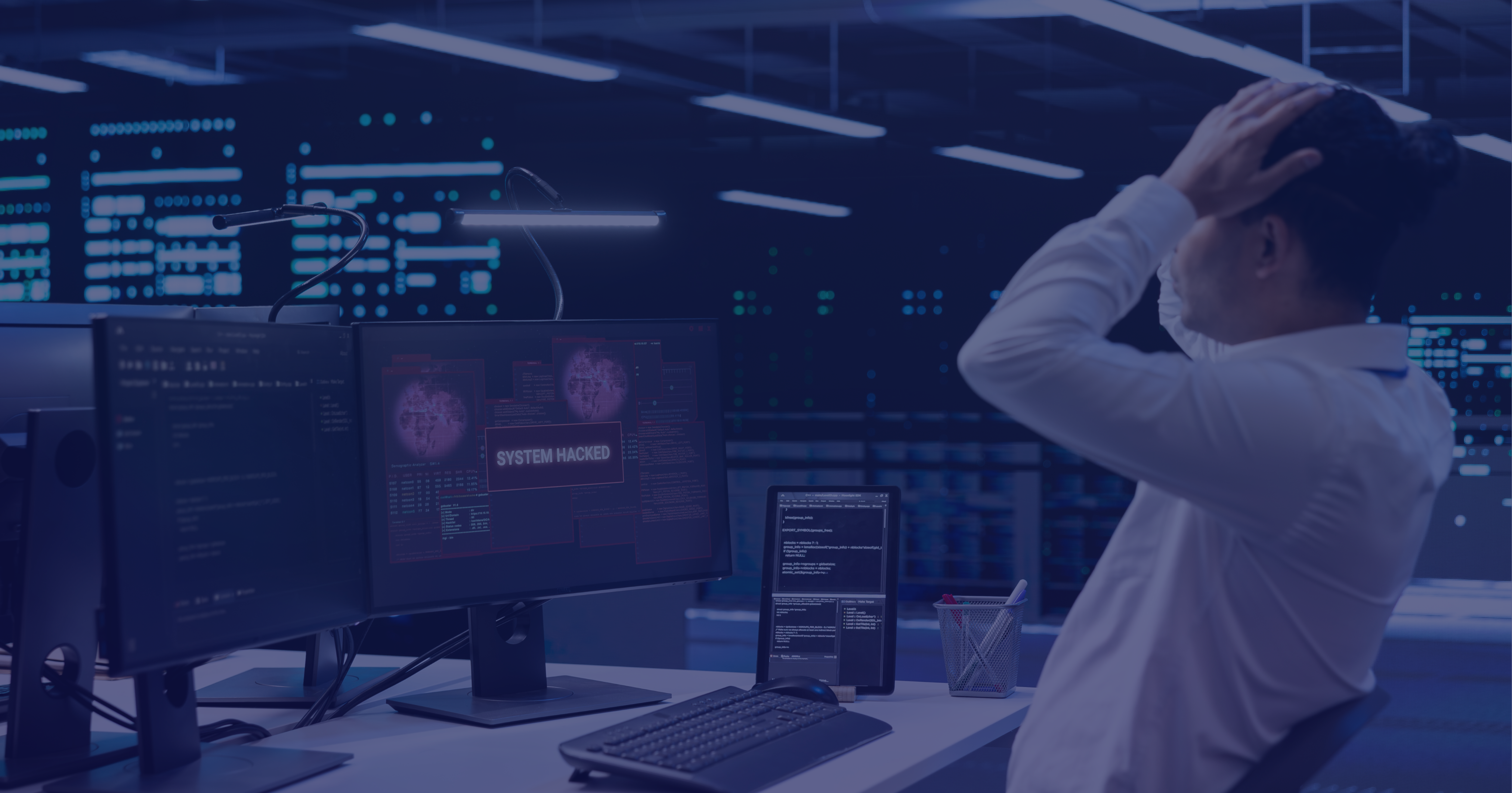 IT security professional in data center with monitors showing system hack alert, overlaid with purple filter suggesting cybersecurity crisis