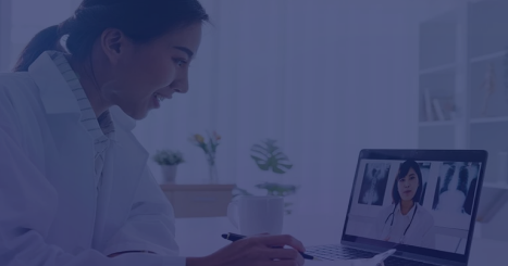 Healthcare professional conducting a virtual patient consultation via laptop with stethoscope and 'Doctor Online' signage – telehealth compliance setup